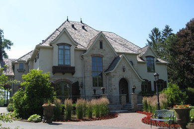 Large elegant beige three-story mixed siding exterior home photo in Chicago with a gambrel roof