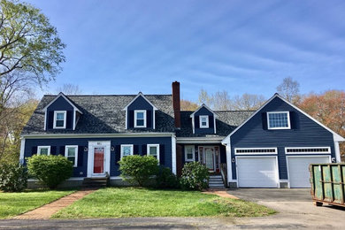 Example of a mid-sized classic blue two-story concrete fiberboard exterior home design in Boston with a shingle roof