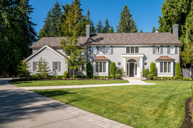Large transitional gray two-story wood exterior home photo in Seattle with a shingle roof