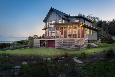 Inspiration for a large transitional gray two-story metal exterior home remodel in Providence with a metal roof