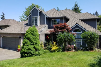 Large transitional blue two-story concrete fiberboard house exterior photo in Portland with a hip roof and a shingle roof