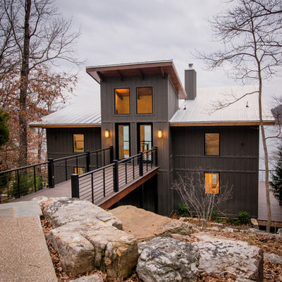 Inspiration for a large rustic gray two-story metal house exterior remodel in Birmingham with a shed roof and a metal roof