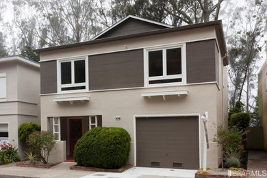 Small 1960s gray two-story stucco exterior home photo in San Francisco with a shingle roof