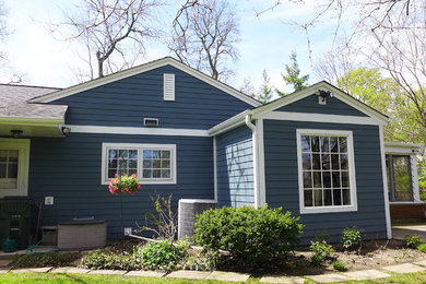 Small elegant blue one-story mixed siding gable roof photo in Chicago