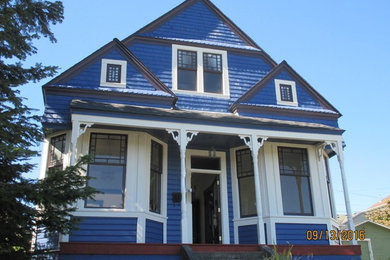 Ejemplo de fachada azul clásica de tamaño medio de dos plantas con revestimiento de madera y tejado a cuatro aguas