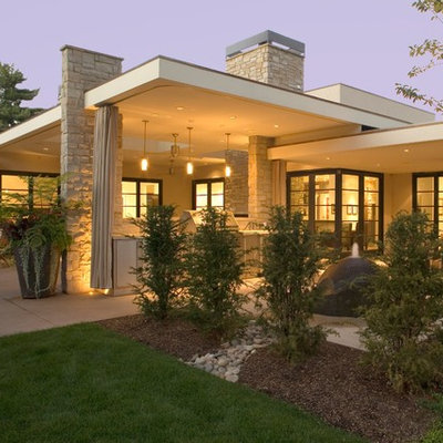 Inspiration for a 1950s one-story flat roof remodel in Denver