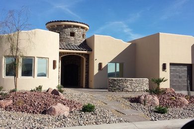Inspiration for a mid-sized southwestern beige one-story stucco flat roof remodel in Las Vegas