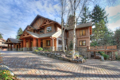 Example of a huge mountain style brown three-story wood exterior home design in Seattle with a shingle roof
