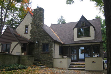 Example of a mountain style beige two-story mixed siding exterior home design in New York