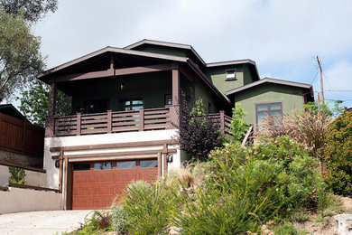 Example of a mid-sized transitional green three-story stucco exterior home design in San Diego with a shingle roof