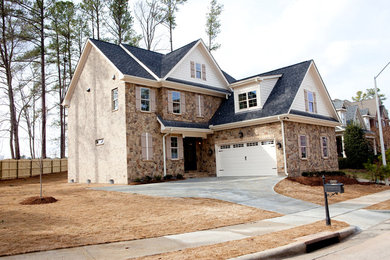 Mid-sized cottage beige two-story stone exterior home photo in Raleigh