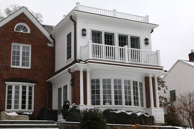 This is an example of a large classic two floor brick and front detached house in Boston.