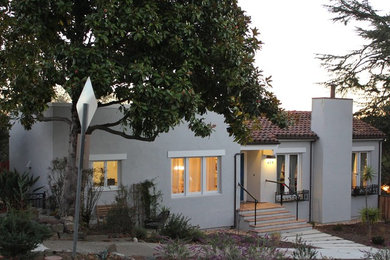 Example of a mid-sized trendy gray two-story stucco exterior home design in San Francisco
