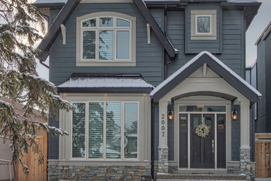 Example of a large classic multicolored two-story mixed siding exterior home design in Calgary with a shingle roof