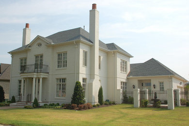 Example of a huge classic white two-story brick house exterior design in Nashville with a clipped gable roof and a shingle roof