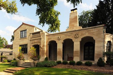 Mid-sized traditional beige two-story stone exterior home idea in Chicago
