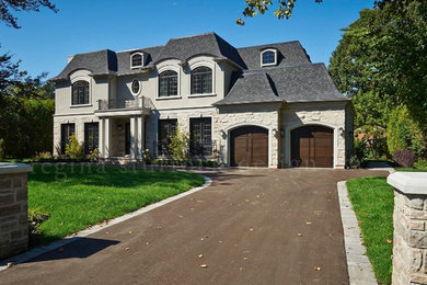 Inspiration for a large transitional two-story stone exterior home remodel in Toronto