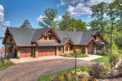 Example of a mountain style brown one-story mixed siding exterior home design in Minneapolis with a shingle roof