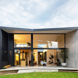 Inspiration for a modern two-storey concrete black house exterior in Sydney with a gable roof.