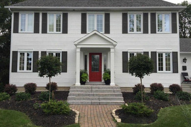 Example of a classic white two-story exterior home design in Ottawa