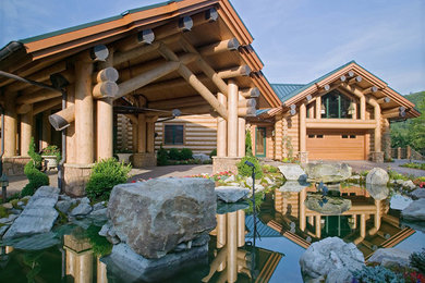 Example of a large mountain style brown one-story wood exterior home design in Other with a metal roof