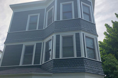 Inspiration for a large victorian black three-story wood exterior home remodel in Boston with a shingle roof