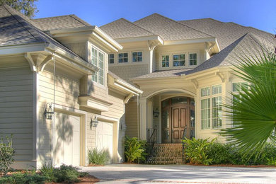 Large elegant beige two-story mixed siding exterior home photo in Charleston with a hip roof