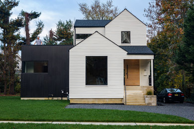 Small modern black two-story concrete fiberboard exterior home idea in Philadelphia with a mixed material roof