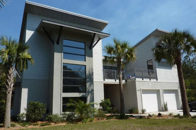 Photo of a large and gey two floor house exterior in Jacksonville with mixed cladding and a flat roof.