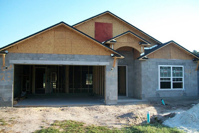 Example of a large two-story stone exterior home design in Miami