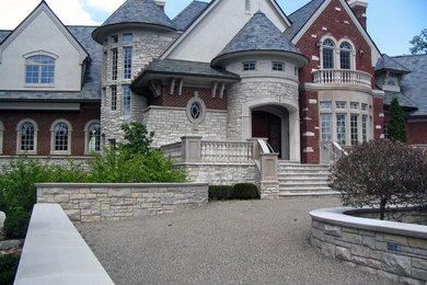Elegant stone exterior home photo in Detroit