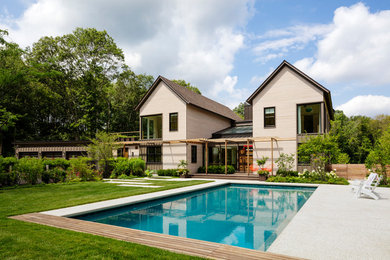 Ejemplo de fachada de casa beige actual grande de dos plantas con tejado a dos aguas y tejado de teja de madera