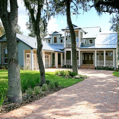 Inspiration for a large timeless blue two-story mixed siding exterior home remodel in Orlando
