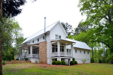 Inspiration for a mid-sized contemporary white two-story wood gable roof remodel in Birmingham