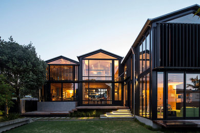 Inspiration for a contemporary two floor glass house exterior in Napier-Hastings.