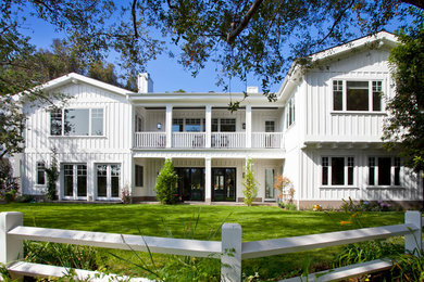 Elegant white two-story wood exterior home photo in Los Angeles