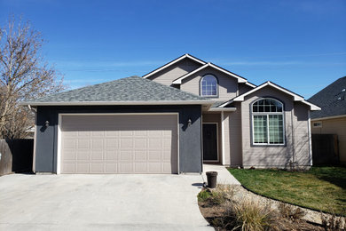 Example of a mid-sized trendy gray one-story concrete fiberboard house exterior design in Boise with a hip roof and a shingle roof