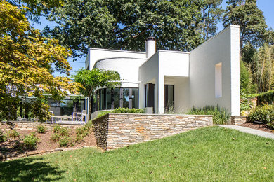Inspiration for a large modern white two-story brick exterior home remodel in Other