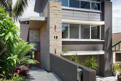 Imagen de fachada de casa marrón moderna grande de tres plantas con revestimiento de piedra, tejado plano y tejado de metal