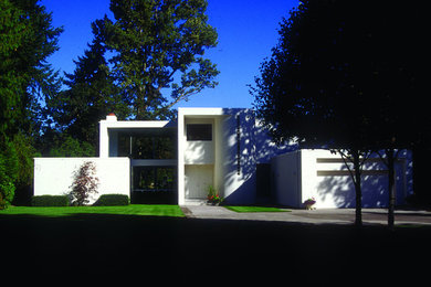 Inspiration for a large modern white three-story stucco exterior home remodel in Portland
