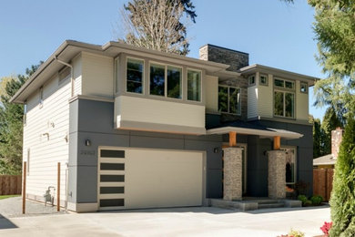 Example of a large trendy beige two-story concrete fiberboard exterior home design in Seattle