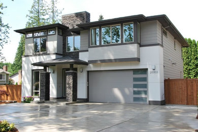 Large contemporary beige two-story concrete fiberboard exterior home idea in Seattle