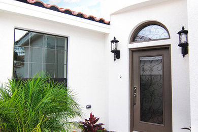 Example of a tuscan beige one-story exterior home design in Austin