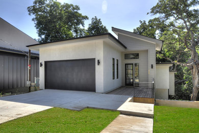 Photo of a large and gey contemporary split-level house exterior in Austin with mixed cladding and a flat roof.