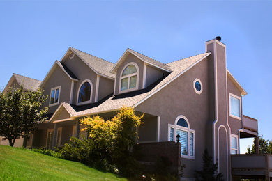 Mid-sized elegant beige two-story stucco gable roof photo in Salt Lake City