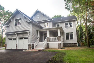 Large arts and crafts gray three-story vinyl exterior home photo in Baltimore with a shingle roof