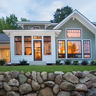Arts and crafts two-story house exterior photo in Other with a shingle roof