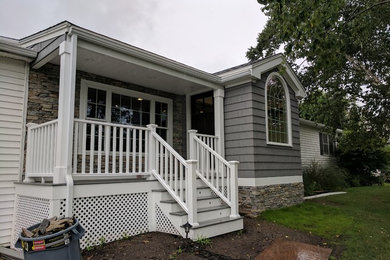 Photo of a medium sized and gey classic bungalow detached house in Boston with wood cladding.