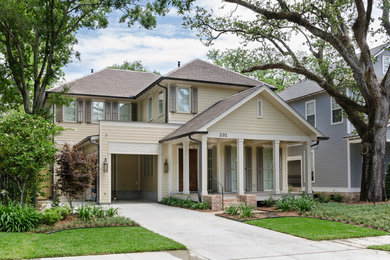 Inspiration for a large timeless beige two-story concrete fiberboard gable roof remodel in New Orleans