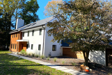 Inspiration for a mid-sized modern white two-story mixed siding house exterior remodel in Philadelphia with a gray roof